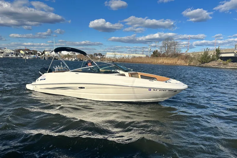 Slide: The Image of 2014 Sea Ray 240 Sundeck Outboard boat cruising on a sunny day with blue skies. - 8