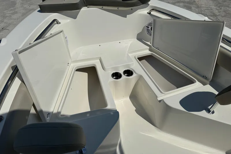 Slide: The Image of 2025 Key West 203 FS boat interior with open storage compartments and cup holders. - 11