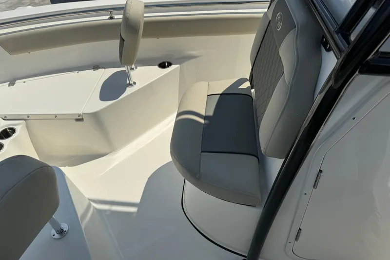 Slide: The Image of 2025 Key West 203 FS boat interior with gray seating and cup holders. - 12