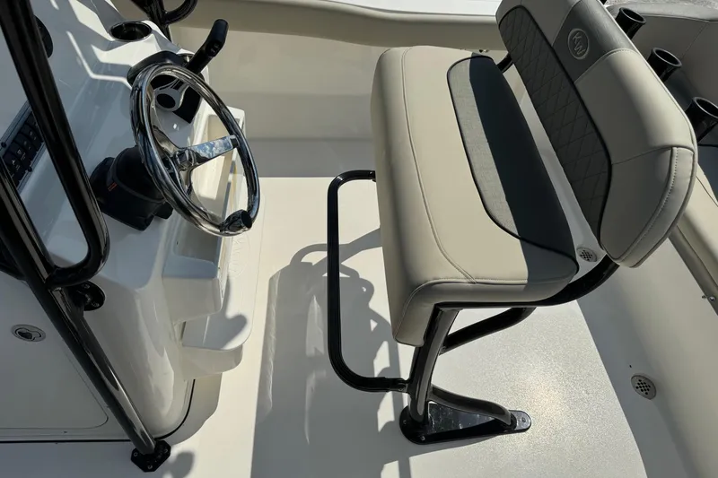 Slide: The Image of 2025 Key West 203 FS boat interior with steering wheel and cushioned seating. - 15