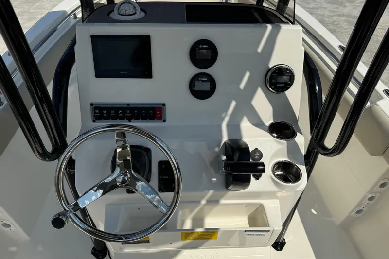Slide: The Image of 2025 Key West 203 FS boat dashboard with steering wheel and control panel. - 16