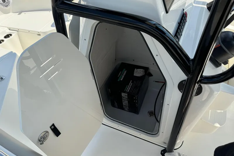 Slide: The Image of 2025 Key West 203 FS boat storage compartment with open door, showing interior space. - 20