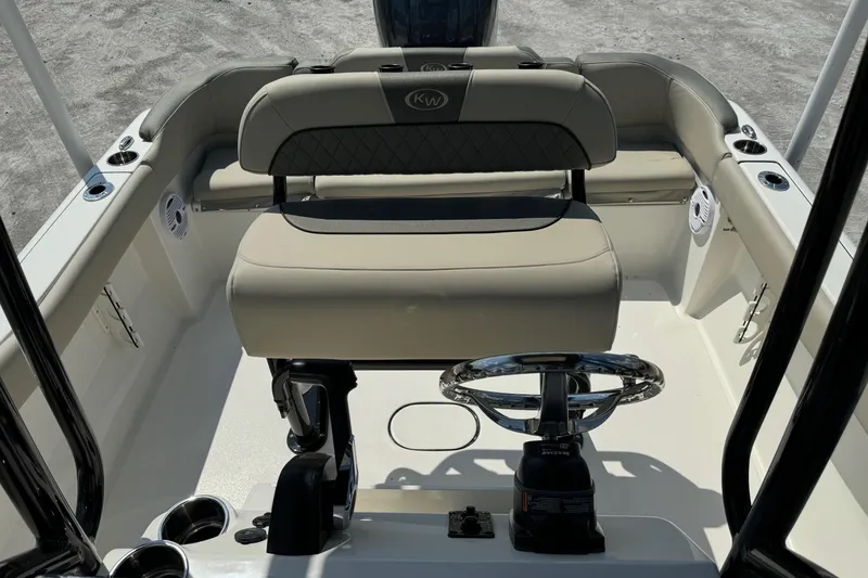 Slide: The Image of 2025 Key West 203 FS boat interior with steering wheel and seating. - 14