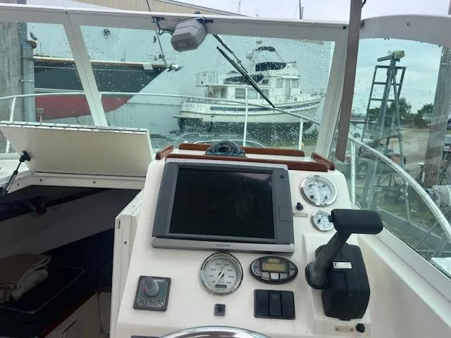 Slide: The Image of 2004 Hunt Yachts Surfhunter 25 helm with navigation instruments and gauges, docked in a marina. - 17