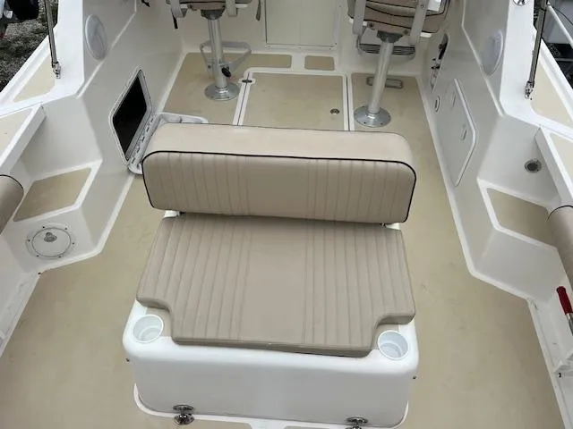 Slide: The Image of 2004 Hunt Yachts Surfhunter 25 interior with beige seating and cup holders. - 19