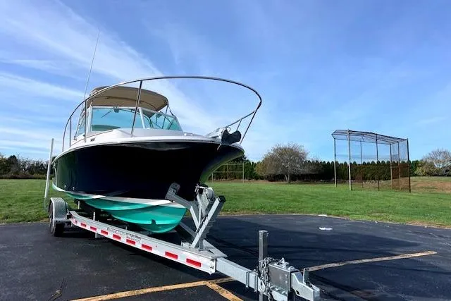 Slide: The Image of 2004 Hunt Yachts Surfhunter 25 on trailer, parked outdoors under clear blue sky. - 3