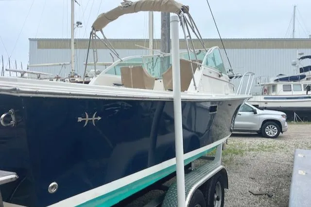 Slide: The Image of 2004 Hunt Yachts Surfhunter 25 on trailer, docked in a marina setting. - 6