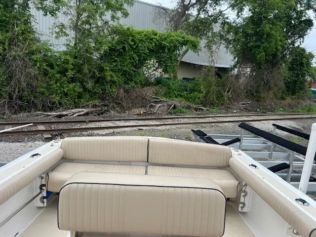 Slide: The Image of 2004 Hunt Yachts Surfhunter 25 with beige seating, near railway tracks and greenery. - 11