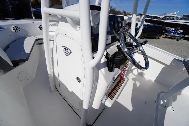 Slide: The Image of 2018 Tidewater 210 LXF boat interior with steering wheel and control panel. - 11