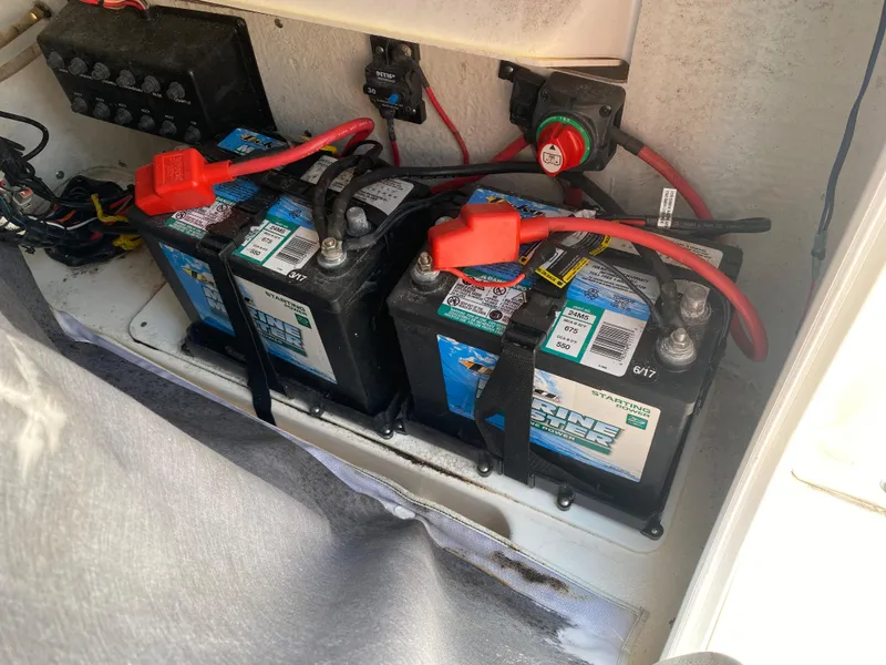 Slide: The Image of Three marine batteries in a 2018 Tidewater 210 LXF boat compartment. - 14