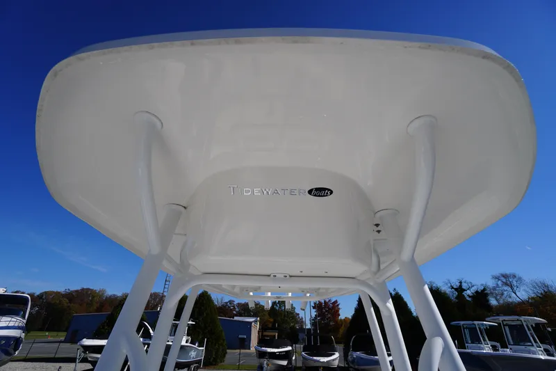 Slide: The Image of 2018 Tidewater 210 LXF boat T-top against clear blue sky. - 16