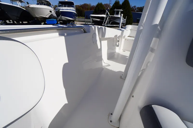 Slide: The Image of 2018 Tidewater 210 LXF boat interior, showcasing sleek white design and spacious layout. - 19