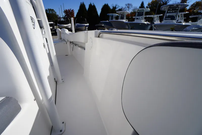 Slide: The Image of 2018 Tidewater 210 LXF boat interior with sleek white design and stainless steel railing. - 20