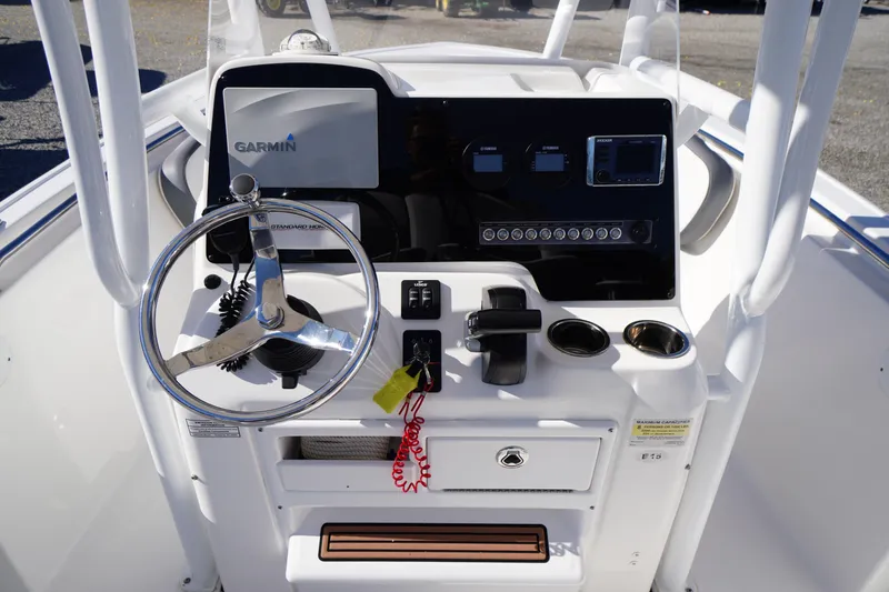 Slide: The Image of 2018 Tidewater 210 LXF boat console with Garmin navigation and steering wheel. - 21