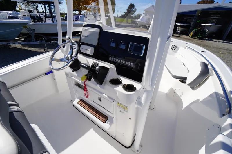 Slide: The Image of 2018 Tidewater 210 LXF boat cockpit with steering wheel and control panel. - 22