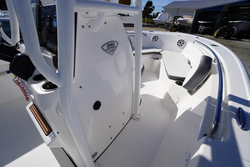 Slide: The Image of 2018 Tidewater 210 LXF boat interior with seating and console details. - 23