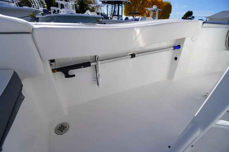 Slide: The Image of 2018 Tidewater 210 LXF boat interior with storage compartment and drain. - 28