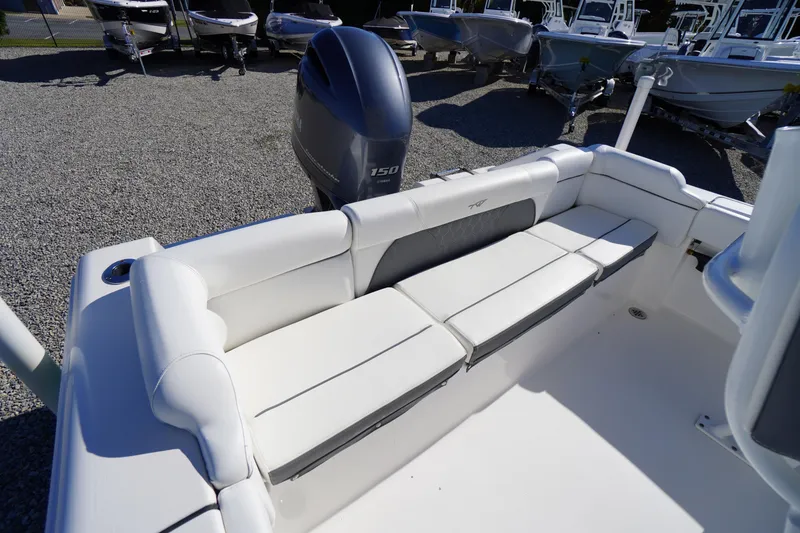 Slide: The Image of 2018 Tidewater 210 LXF boat with white seating and outboard motor in a gravel lot. - 30