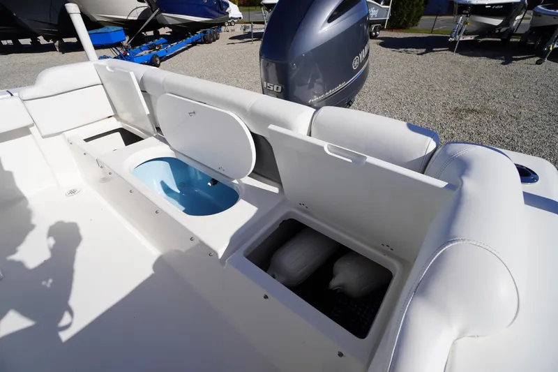 Slide: The Image of 2018 Tidewater 210 LXF boat interior with storage compartments and Yamaha engine. - 34