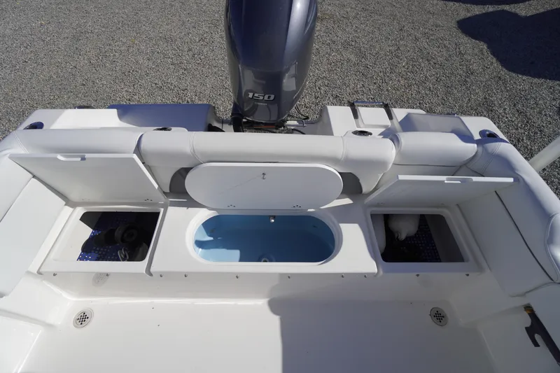 Slide: The Image of 2018 Tidewater 210 LXF boat with open storage compartments and Yamaha 150 engine. - 35