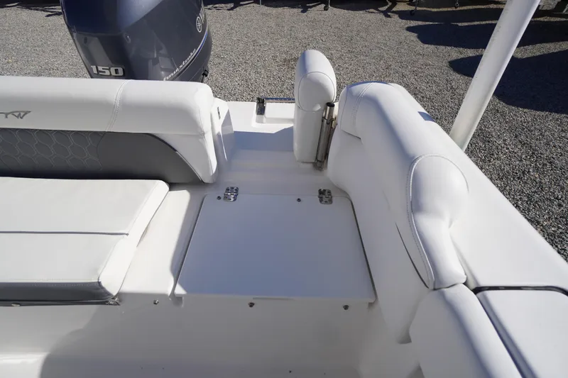 Slide: The Image of 2018 Tidewater 210 LXF boat interior with white seating and Yamaha 150 engine. - 44