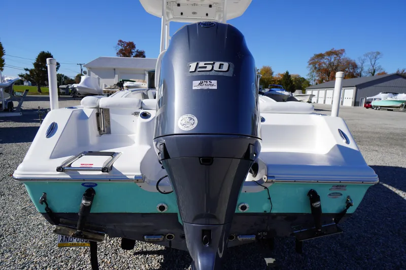 Slide: The Image of 2018 Tidewater 210 LXF boat with 150 HP engine, parked outdoors. - 45