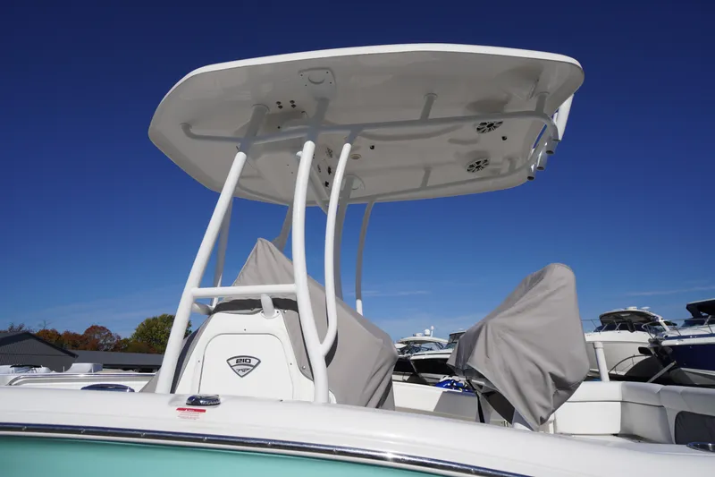 Slide: The Image of 2018 Tidewater 210 LXF boat with T-top against clear blue sky. - 52