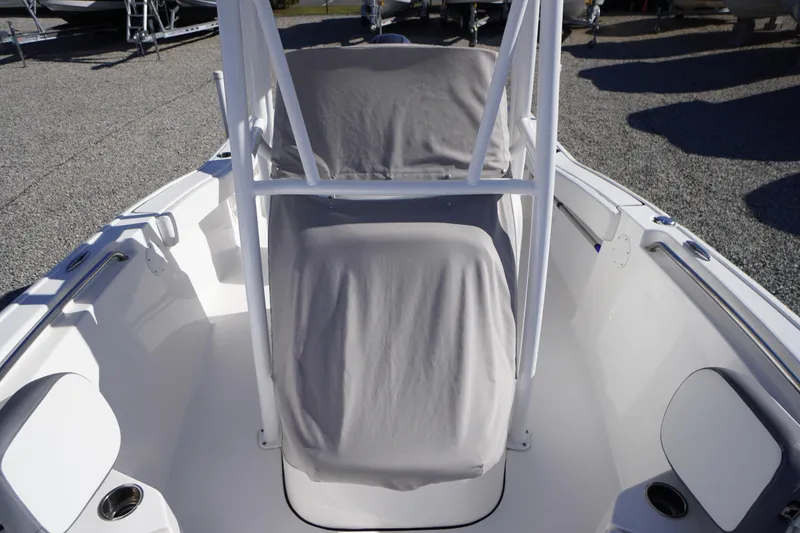 Slide: The Image of 2018 Tidewater 210 LXF boat interior with covered seating and white framework. - 53