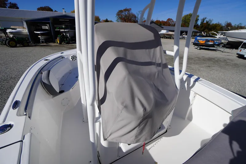Slide: The Image of 2018 Tidewater 210 LXF boat interior with covered console, parked outdoors. - 54