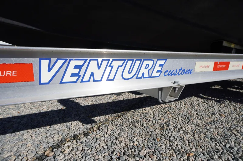 Slide: The Image of Trailer for 2018 Tidewater 210 LXF boat with "Venture Custom" branding. - 56