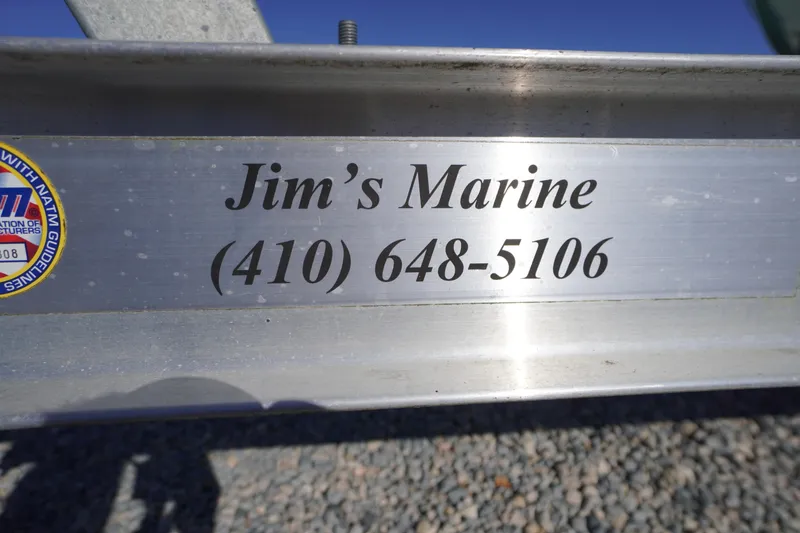 Slide: The Image of Jim's Marine contact information on a metal surface, featuring a phone number. - 57