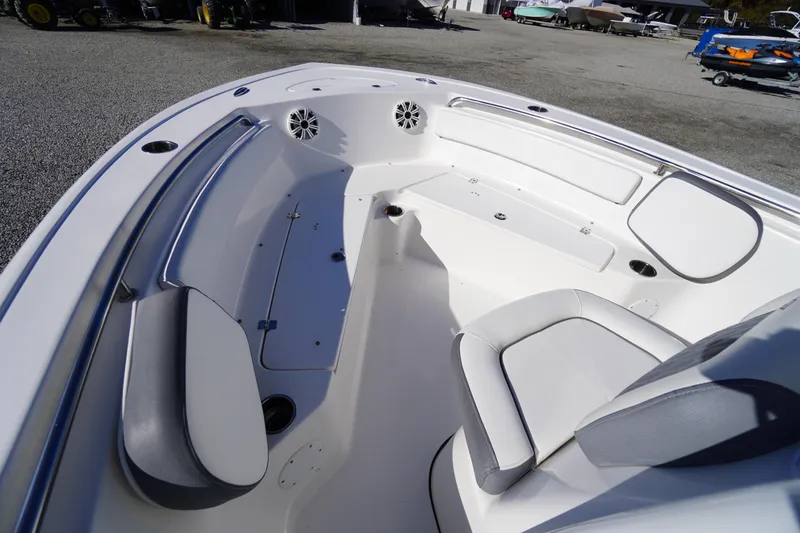 Slide: The Image of 2018 Tidewater 210 LXF boat interior with white seating and storage compartments. - 8
