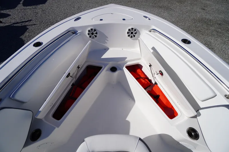 Slide: The Image of 2018 Tidewater 210 LXF boat with open storage compartments and visible life jackets. - 9