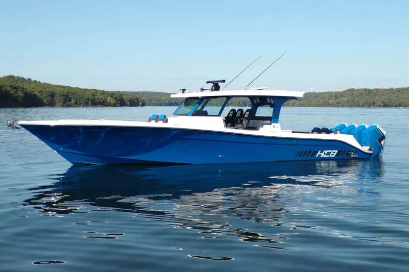 Slide: The Image of 2025 HCB 48 Campeon boat on calm water, featuring sleek blue design and modern amenities. - 1