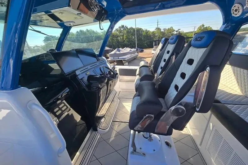 Slide: The Image of Interior of 2025 HCB 48 Campeon boat with modern seating and control panel. - 11