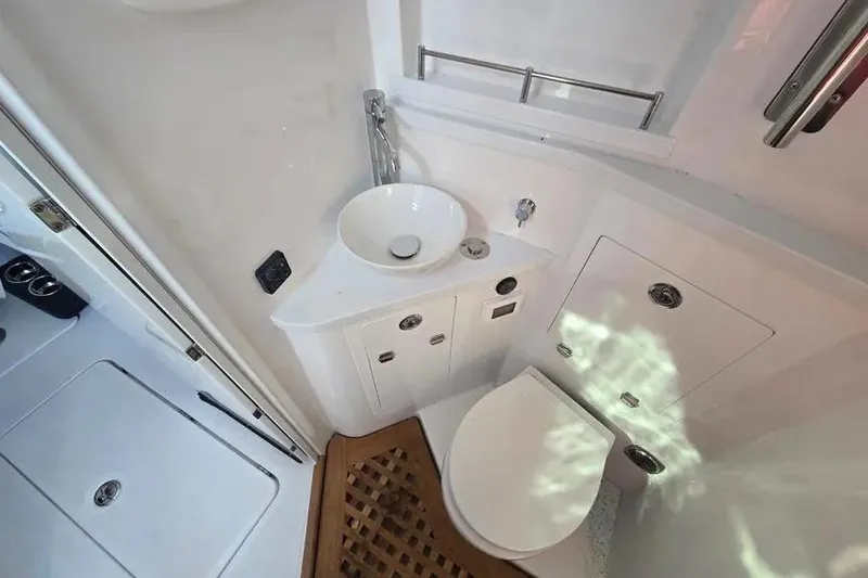 Slide: The Image of Compact bathroom in 2025 HCB 48 Campeon boat with modern fixtures and wooden floor mat. - 20