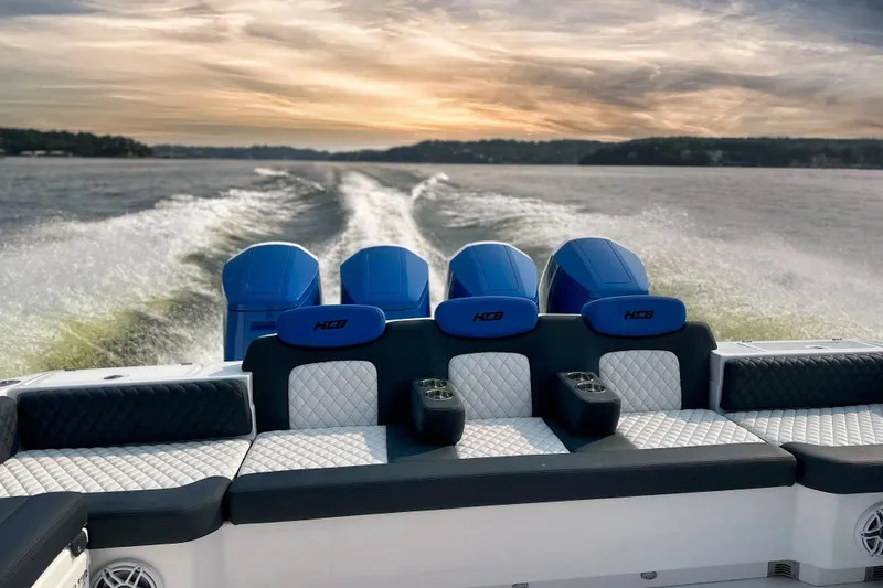 Slide: The Image of 2025 HCB 48 Campeon boat cruising on a lake at sunset. - 23