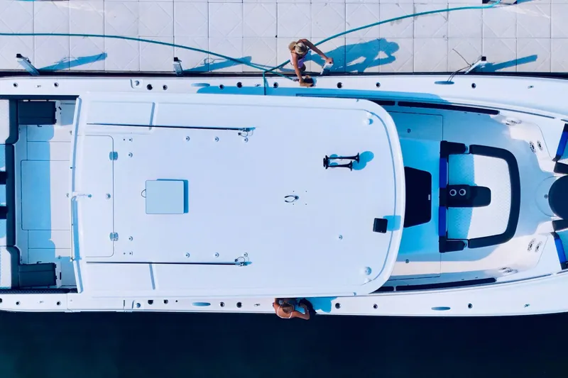 Slide: The Image of Aerial view of 2025 HCB 48 Campeon yacht docked, with people on deck. - 3