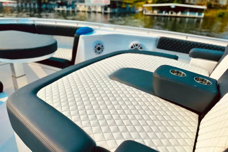 Slide: The Image of Luxurious seating on 2025 HCB 48 Campeon boat with quilted upholstery and cup holders. - 6