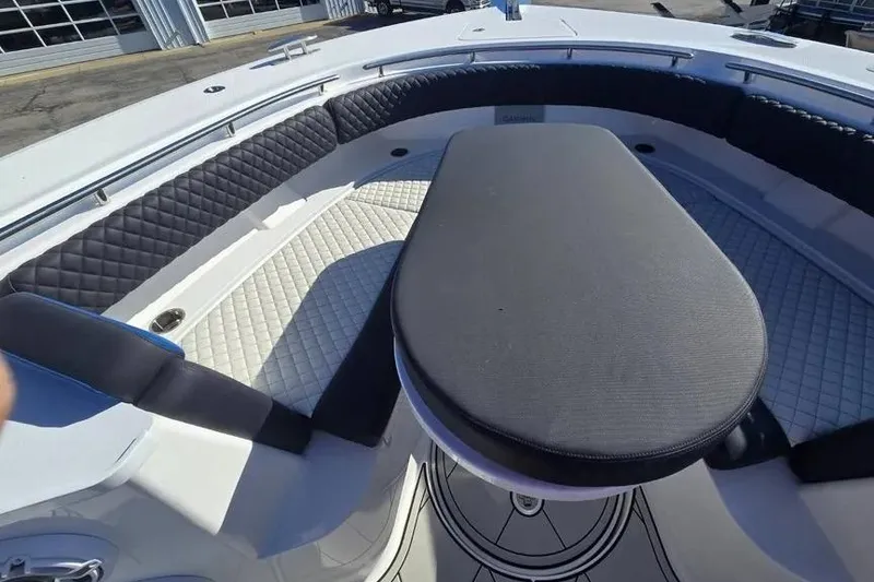 Slide: The Image of 2025 HCB 48 Campeon boat interior with cushioned seating and table. - 8