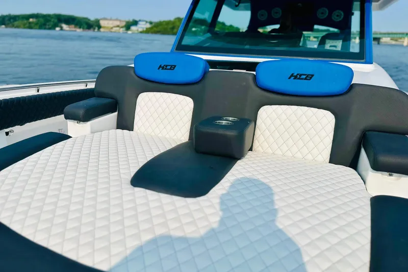 Slide: The Image of Luxurious seating on 2025 HCB 48 Campeon boat with quilted upholstery and cup holders. - 9