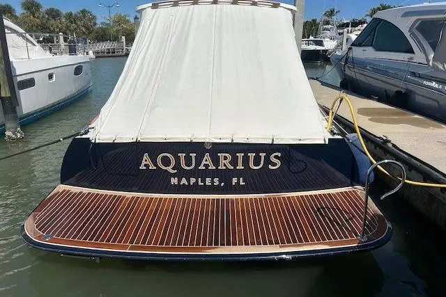 Slide: The Image of 2024 Hinckley Talaria 43 MY yacht "Aquarius" docked in Naples, FL marina. - 1