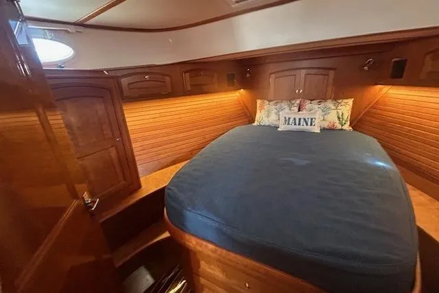 Slide: The Image of Luxurious cabin interior of 2024 Hinckley Talaria 43 MY yacht with wood finish and cozy bedding. - 5