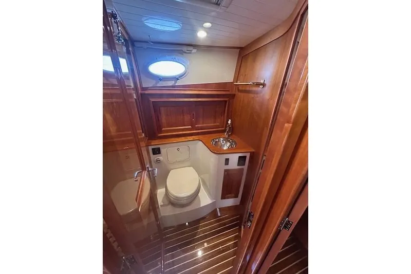 Slide: The Image of Luxurious 2024 Hinckley Talaria 43 MY yacht bathroom with wood accents and modern fixtures. - 6
