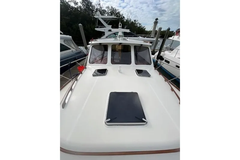 Slide: The Image of 2024 Hinckley Talaria 43 MY yacht docked, showcasing sleek deck design and modern features. - 7