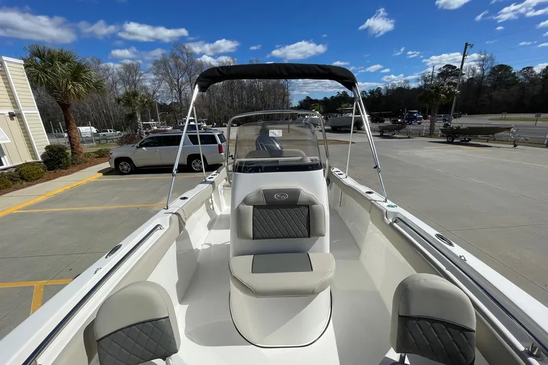 Slide: The Image of 2026 Key West 203 FS boat with seating, parked outdoors under a clear sky. - 13