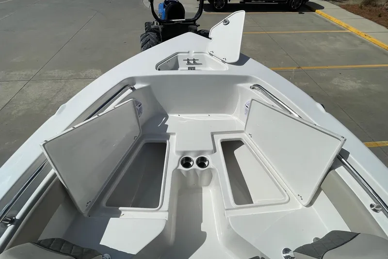 Slide: The Image of 2026 Key West 203 FS boat interior with open storage compartments and cup holders. - 17