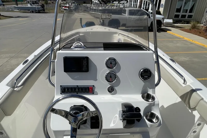 Slide: The Image of 2026 Key West 203 FS boat dashboard with steering wheel, gauges, and controls. - 19