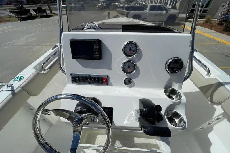 Slide: The Image of 2026 Key West 203 FS boat dashboard with steering wheel, gauges, and controls. - 9