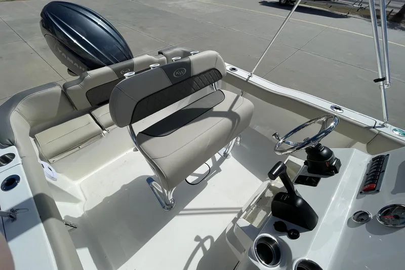 Slide: The Image of 2026 Key West 203 FS boat interior with steering wheel and seating. - 11
